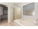 The bright bathroom features a separate glass shower and soaking tub at 2233 S Nielson St, Gilbert, AZ 85295