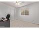 Bright bedroom with plush carpeting, a ceiling fan, and a window with wood-look blinds at 2233 S Nielson St, Gilbert, AZ 85295