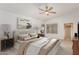This staged bedroom features neutral tones, and a ceiling fan at 2233 S Nielson St, Gilbert, AZ 85295