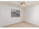 This cozy bedroom features a ceiling fan and a large window for natural light at 2233 S Nielson St, Gilbert, AZ 85295