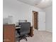 This bedroom features neutral carpet, white walls, and ample space for a computer and chair at 2233 S Nielson St, Gilbert, AZ 85295