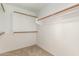 This closet offers plenty of space with multiple shelves and clothing rods at 2233 S Nielson St, Gilbert, AZ 85295