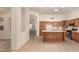 Spacious kitchen with ample cabinetry and a kitchen island, seamlessly connecting to a cozy living area at 2233 S Nielson St, Gilbert, AZ 85295