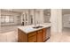 Kitchen island with modern countertops and stainless steel appliances, connecting to a spacious living area at 2233 S Nielson St, Gilbert, AZ 85295