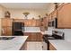 Modern kitchen featuring wooden cabinets, granite counters, and stainless steel appliances at 2233 S Nielson St, Gilbert, AZ 85295