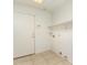 Bright laundry room features tile flooring and a door to the exterior at 2233 S Nielson St, Gilbert, AZ 85295