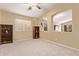 Bright living room with carpet, vaulted ceiling, natural light and open view to another room at 2233 S Nielson St, Gilbert, AZ 85295