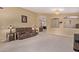 Cozy living room with comfortable seating, chandelier, and neutral walls, open to kitchen at 2233 S Nielson St, Gilbert, AZ 85295