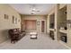 Comfortable living room features fireplace, TV, carpet, ceiling fan, and plenty of light at 2233 S Nielson St, Gilbert, AZ 85295