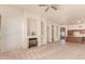 Bright living room boasts a cozy fireplace, neutral decor, and seamless flow into the adjacent kitchen area at 2233 S Nielson St, Gilbert, AZ 85295
