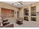 Cozy living room features a fireplace, built-in shelving, and neutral color palette at 2233 S Nielson St, Gilbert, AZ 85295