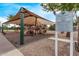 Playground with tan shade structure, green posts, red ladders and a sign at 2233 S Nielson St, Gilbert, AZ 85295