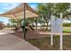 Wide view of covered playground with green slide, red railings and gravel surface at 2233 S Nielson St, Gilbert, AZ 85295