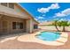Backyard pool area with desert landscaping, covered patio, and house view at 2233 S Nielson St, Gilbert, AZ 85295