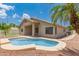 Relaxing backyard pool view featuring desert landscaping and a covered patio at 2233 S Nielson St, Gilbert, AZ 85295