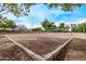 An outdoor volleyball court with tall net surrounded by green trees and clear blue sky at 2233 S Nielson St, Gilbert, AZ 85295