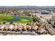 Breathtaking aerial view of a golf course community featuring manicured greens and serene water features and houses with solar panels at 22940 W Desert Bloom St, Buckeye, AZ 85326