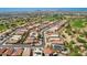 Extensive aerial view of a residential neighborhood featuring well-maintained homes and lush green spaces in a Primary planned community at 22940 W Desert Bloom St, Buckeye, AZ 85326