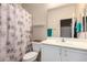 Well-maintained bathroom featuring a shower-tub combination and a seashell-themed shower curtain at 22940 W Desert Bloom St, Buckeye, AZ 85326
