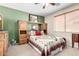 Comfortable bedroom featuring a quilt-covered bed, matching headboard, dresser, and bedside tables at 22940 W Desert Bloom St, Buckeye, AZ 85326