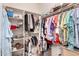 Walk-in closet with ample storage for clothes, shoes, and accessories neatly organized at 22940 W Desert Bloom St, Buckeye, AZ 85326