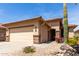 Charming home exterior showcasing desert landscaping and a two-car garage at 22940 W Desert Bloom St, Buckeye, AZ 85326