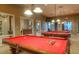 Elegant game room with well-lit billiard tables, creating a perfect entertainment space at 22940 W Desert Bloom St, Buckeye, AZ 85326