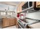 Well-equipped kitchen with stainless steel appliances and oak cabinets at 22940 W Desert Bloom St, Buckeye, AZ 85326