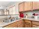 Close-up of the kitchen sink and countertop with small kitchen appliances on display at 22940 W Desert Bloom St, Buckeye, AZ 85326