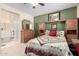 Spacious main bedroom suite showing a quilt-covered bed and adjoining bathroom with dual sink vanity at 22940 W Desert Bloom St, Buckeye, AZ 85326