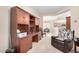 Inviting office space with custom wooden built-ins, desk, and cozy chair in neutral tones at 22940 W Desert Bloom St, Buckeye, AZ 85326