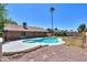 Inviting backyard pool area with a well maintained lawn and a desert landscape at 2322 E Dolphin Ave, Mesa, AZ 85204