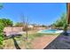Spacious backyard featuring a refreshing pool, a grassy area, and landscaping at 2322 E Dolphin Ave, Mesa, AZ 85204