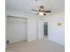 Bright carpeted bedroom with ceiling fan and large closet space at 2322 E Dolphin Ave, Mesa, AZ 85204
