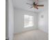 Bright, carpeted bedroom with ceiling fan and a window providing natural light at 2322 E Dolphin Ave, Mesa, AZ 85204