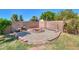 The backyard fire pit is surrounded by stone and rock, creating a perfect spot to relax at 2322 E Dolphin Ave, Mesa, AZ 85204