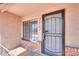 Close-up of the front door entrance with security screen and brick accents at 2322 E Dolphin Ave, Mesa, AZ 85204