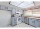 Charming kitchen featuring tile flooring, modern appliances, and plenty of cabinet space at 2322 E Dolphin Ave, Mesa, AZ 85204