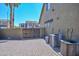 The backyard with brick pavers, block wall, and multiple HVAC units at 248 S 167Th Dr, Goodyear, AZ 85338