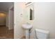 This bathroom includes a pedestal sink, toilet, and a large mirror at 248 S 167Th Dr, Goodyear, AZ 85338