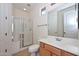 Bright bathroom features a glass shower, vanity with storage, and neutral color palette at 248 S 167Th Dr, Goodyear, AZ 85338