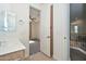 Bathroom with vanity and door to main bedroom and a view to the upstairs hallway at 248 S 167Th Dr, Goodyear, AZ 85338