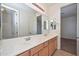 Bathroom featuring double sinks, a large mirror, and well-lit vanity at 248 S 167Th Dr, Goodyear, AZ 85338