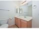 Bright bathroom featuring a wooden vanity, large mirror and towel rack at 248 S 167Th Dr, Goodyear, AZ 85338