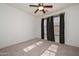 Bright bedroom features neutral carpeting, a modern ceiling fan, and large window with dark curtains at 248 S 167Th Dr, Goodyear, AZ 85338