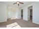 Well-lit bedroom with neutral carpet, a ceiling fan, and double door closet for ample storage at 248 S 167Th Dr, Goodyear, AZ 85338