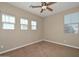 Inviting bedroom featuring carpet, ceiling fan, and window for a cozy and relaxing atmosphere at 248 S 167Th Dr, Goodyear, AZ 85338