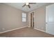 Cozy bedroom features carpet, a ceiling fan, and a window, creating a warm and inviting space at 248 S 167Th Dr, Goodyear, AZ 85338
