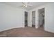 Spacious bedroom with neutral carpet, a ceiling fan, and three doors, great for flexible use at 248 S 167Th Dr, Goodyear, AZ 85338
