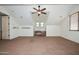 This carpeted bonus room has a ceiling fan and many windows for natural light at 248 S 167Th Dr, Goodyear, AZ 85338